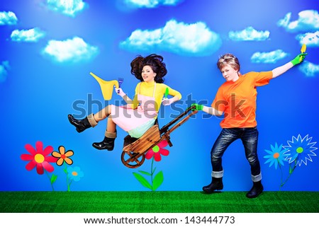 Couple of young people in love running with flowers.