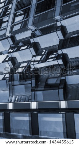 Monochrome cyanotype picture of a futuristic square steel building suspended in the air in a dystopian metropolis.
