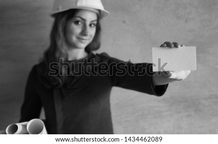 woman with a blank sheet of paper in his hand on a construction site
