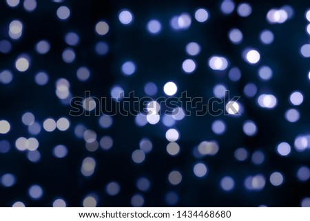 abstract blurred of blue and silver glittering shine lights background, Christmas wallpaper decorations concept, parkle circle lit celebrations display