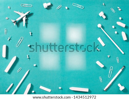 White stationary and education supplies on blue background with several piece of paper with negative space. Flat lay.  Back to school background.