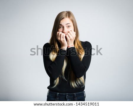 beautiful blonde woman scared isolated on background