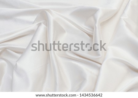 Abstract background texture of natural light color fabric. Fabric texture of natural cotton or linen, silk or satin, wool or jersey textile material. Luxurious white canvas background.

