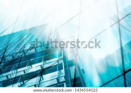 Light turquoise ,blue steel, skyscraper reflection perspective background,  high glass building with sun reflect and flare .modern commercial city background, trending future of business concept. Royalty-Free Stock Photo #1434554522