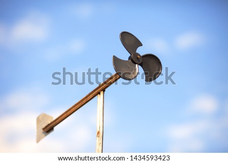 Weathervane - a device for measuring the direction and speed of the wind with a plate rotating on a vertical rod.