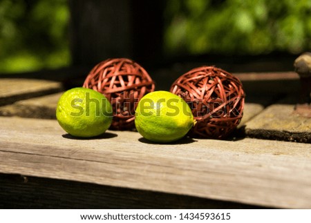 Ball of wood. With lime fruit. With place for calligraphy.