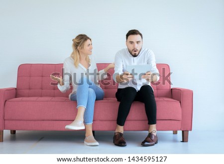Bored and disregard couple lover sitting on sofa in living room in the house together,Family issues Royalty-Free Stock Photo #1434595127