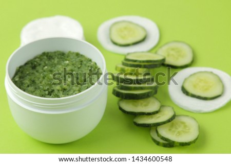 Face mask with cucumber. Cosmetics with cucumber extract on a bright green background. spa. beauty.