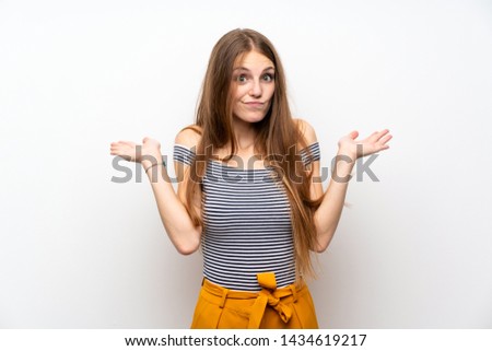 Young woman with long hair over isolated white wall having doubts while raising hands