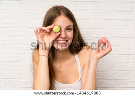 Young girl in a kitchen with macaroons