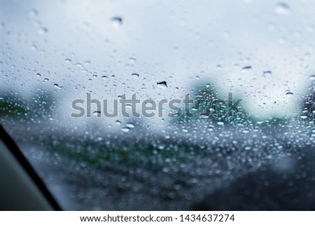 lurred image, raindrop on the windshield, the windshield view.