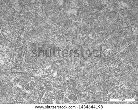 Microstructure of steel toe insert at carburized and non-carburized regions showing martensite and tempered martensite. Etched w/ 2% nital Royalty-Free Stock Photo #1434644198