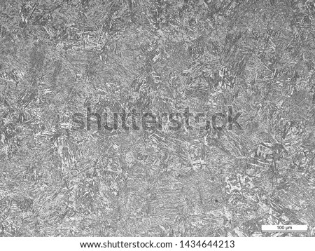 Microstructure of steel toe insert at carburized and non-carburized regions showing martensite and tempered martensite. Etched w/ 2% nital Royalty-Free Stock Photo #1434644213