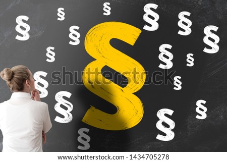 woman looking at blackboard filled with section signs or paragraph marks, legal problems concept Royalty-Free Stock Photo #1434705278