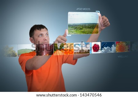 Man looks at photos of the virtual display. Concept