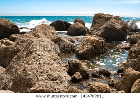 Large stones protrude from the waters of the Black Sea.  Stone jungle on the coast of the Black Sea.