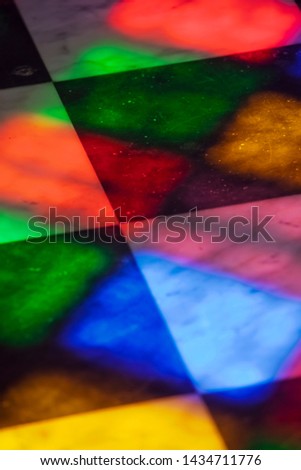 Reflection on the floor from vivid colors of stained glass windows