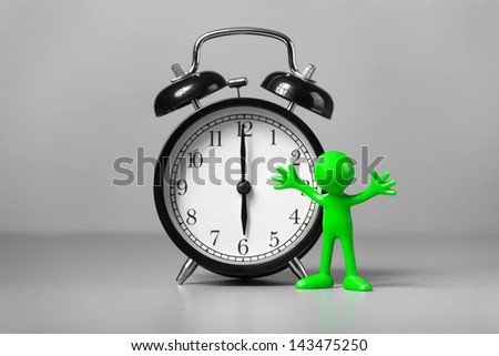 Green man and an alarm clock. The concept of time.