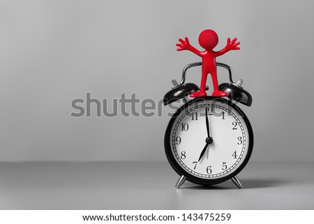 Red man and an alarm clock. The concept of time.
