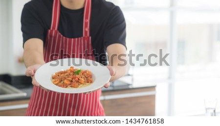 Cropped view of man preparing a delicious healthy spaghetti tomato sauce and presentation food