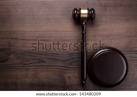 judge gavel on the brown wooden background Royalty-Free Stock Photo #143480209