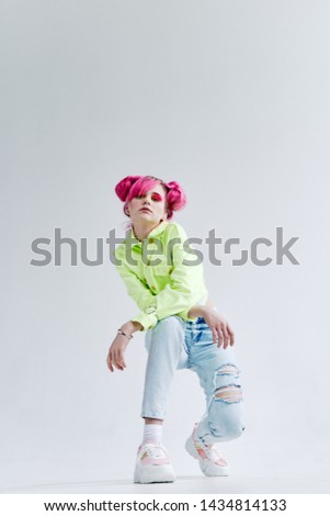 woman with pink hair sitting on the floor