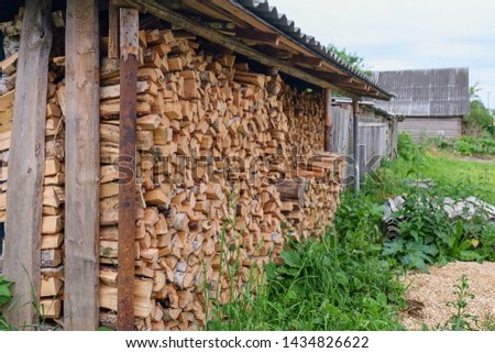 Neat stack of cut firewood for a log burning stove in countryside