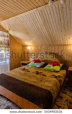The interior of the hotel. Beautiful, magnificent view, background, panorama of a wooden, retro and vintage style interior of a cozy bedroom, hotel rooms, villa rooms, houses, summer day.