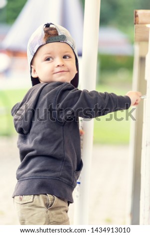 Portrait of a little boy in a baseball cap backwards. Shallow depth of field.