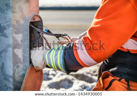 Electrician. Man fixing electricity street pole. LED light.  Industrial And Commercial LED light for street pole. LED light lamp stock photo Royalty-Free Stock Photo #1434930005