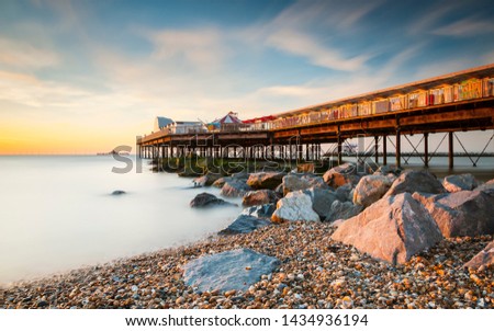 Herne Bay Pier. A colourful image of the pier taken at sunset leading the eye to the old disused pier head out at sea.