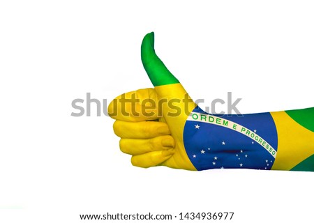 Brazil Falg. Hand showing the sign of like and okay. Close up of female hand showing victory sign isolated on white background. Woman hand gesturing peace sign.