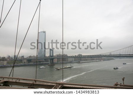 perspective view of the Brooklyn Bridge and the skyline on a cloudy day. Manhattan, New York, May 2019