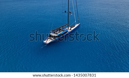 Aerial photo of beautiful wooden deck sail boat cruising the Aegean blue sea, Greece