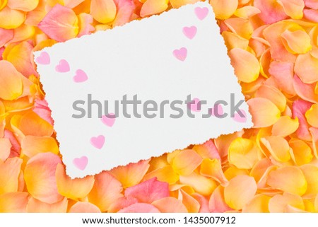 background of pink rose petals, paper sheet and pink hearts