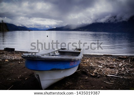 fisherman's boat anchored in some beach of lake Rupanco