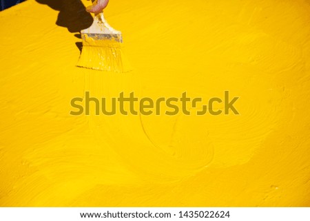 Yellow paint on the metal. Brush painted in the yellow playground. The background is yellow