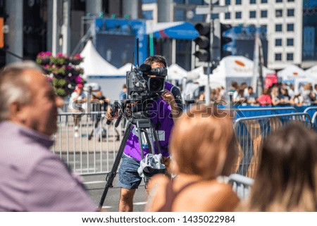 TV Camera Operator at the live event. Television. Telecast. Correspondent. Viewers