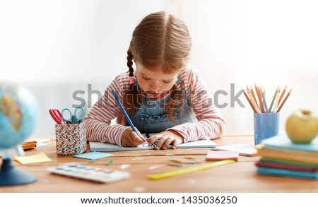 a funny child  girl  doing homework writing and reading at home
 Royalty-Free Stock Photo #1435036250