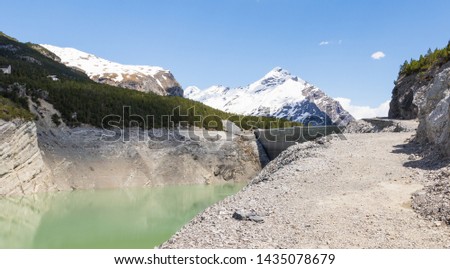 hydroelectric site on Alps with dam and artificial lake