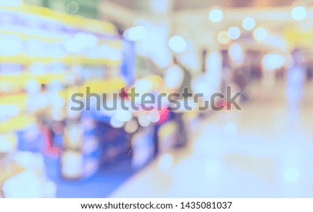 Vintage tone abstract blur image of Shopping mall or Exhibition hall with bokeh for background usage .