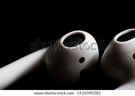 Airpod closeup on a black background Royalty-Free Stock Photo #1435090382