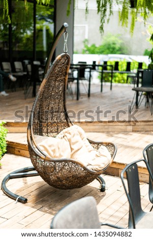 outdoor patio wicker swing chair with pillows
