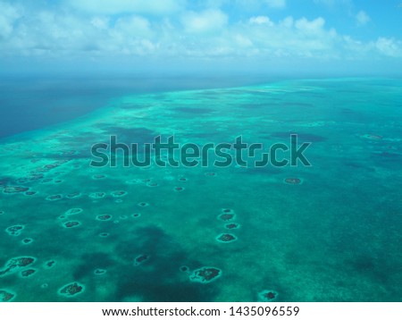 Turneffe Atoll from the air. belize marine aerial view of the reef and atoll. on the blue hole flight Royalty-Free Stock Photo #1435096559