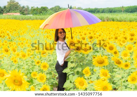 Woman holding umbrellas in sunflower fields Hot and clear in the daytime
