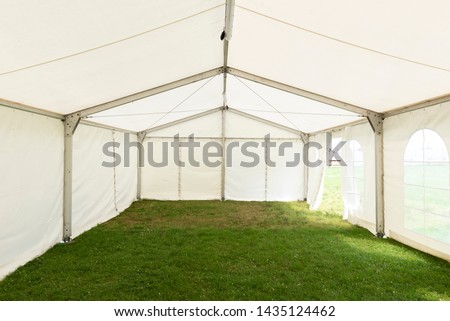 Inside empty white tent waiting for event arrangement Royalty-Free Stock Photo #1435124462