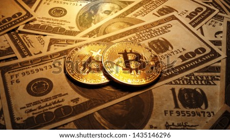 Real coin of Bitcoin over dollar bank notes,real golden coin bitcoin virtual currency.