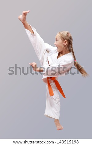 Professional girl does karate kick Royalty-Free Stock Photo #143515198