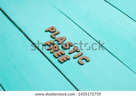 Plastic free concept. Blue wooden background with text plastic free