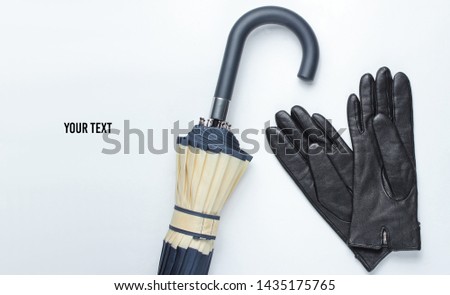 Autumn women's accessories. Leather gloves, umbrella on a white background. Copy space. Top view.